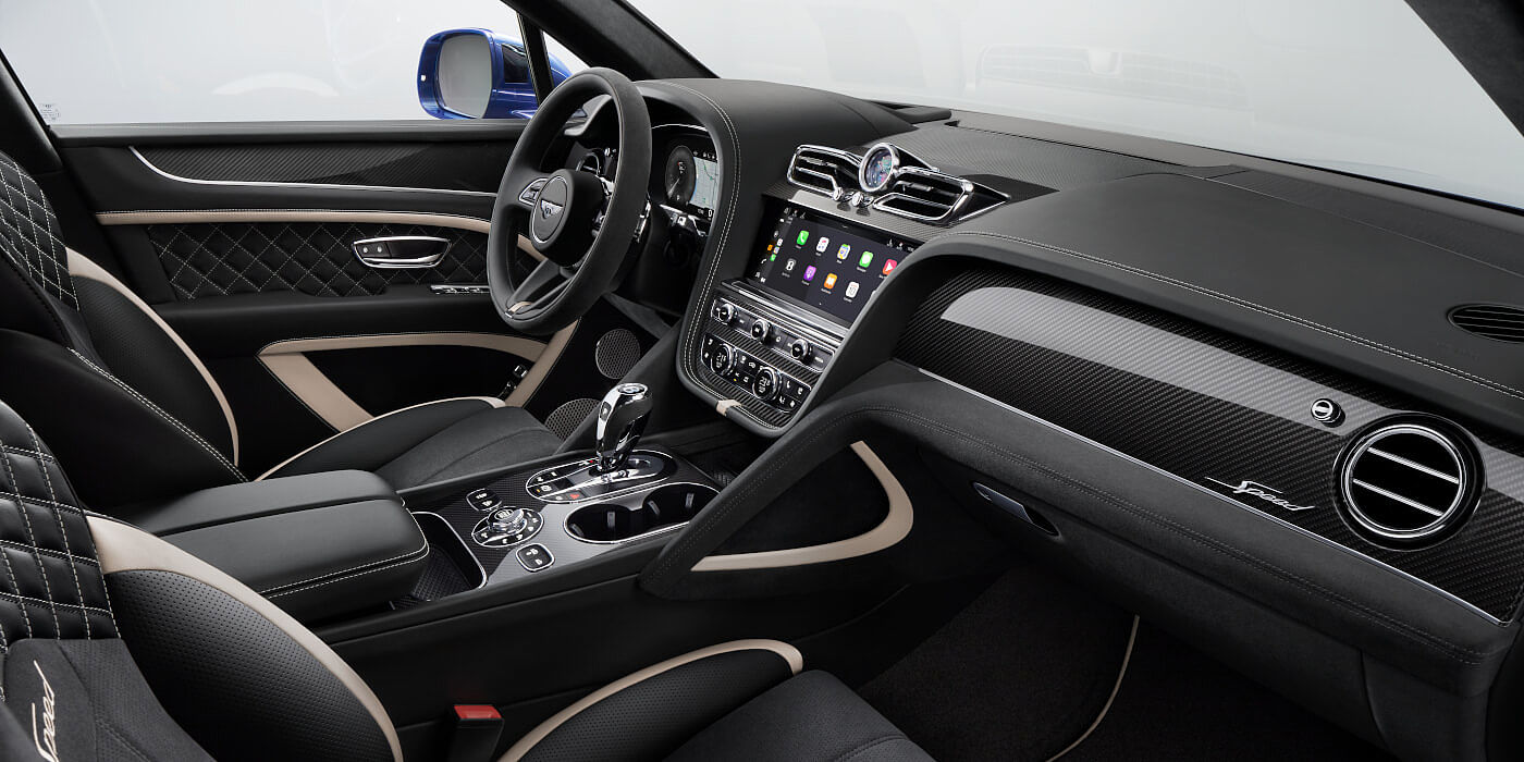 Bentley Santiago Bentley Bentayga Speed SUV front interior in Beluga black and Linen hide with carbon fibre veneer
