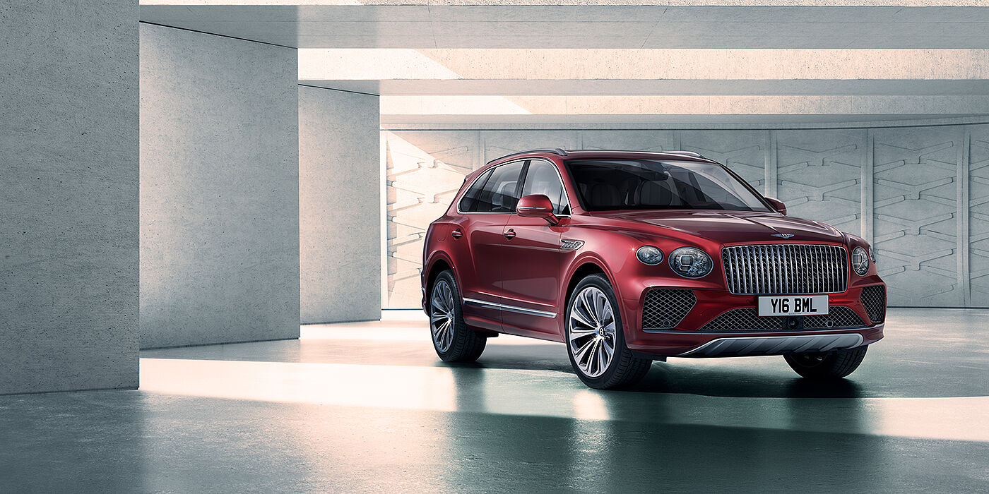 Bentley Santiago Bentley Bentayga Atelier Edition SUV in Rubino Red paint front three quarter against textured concrete wall