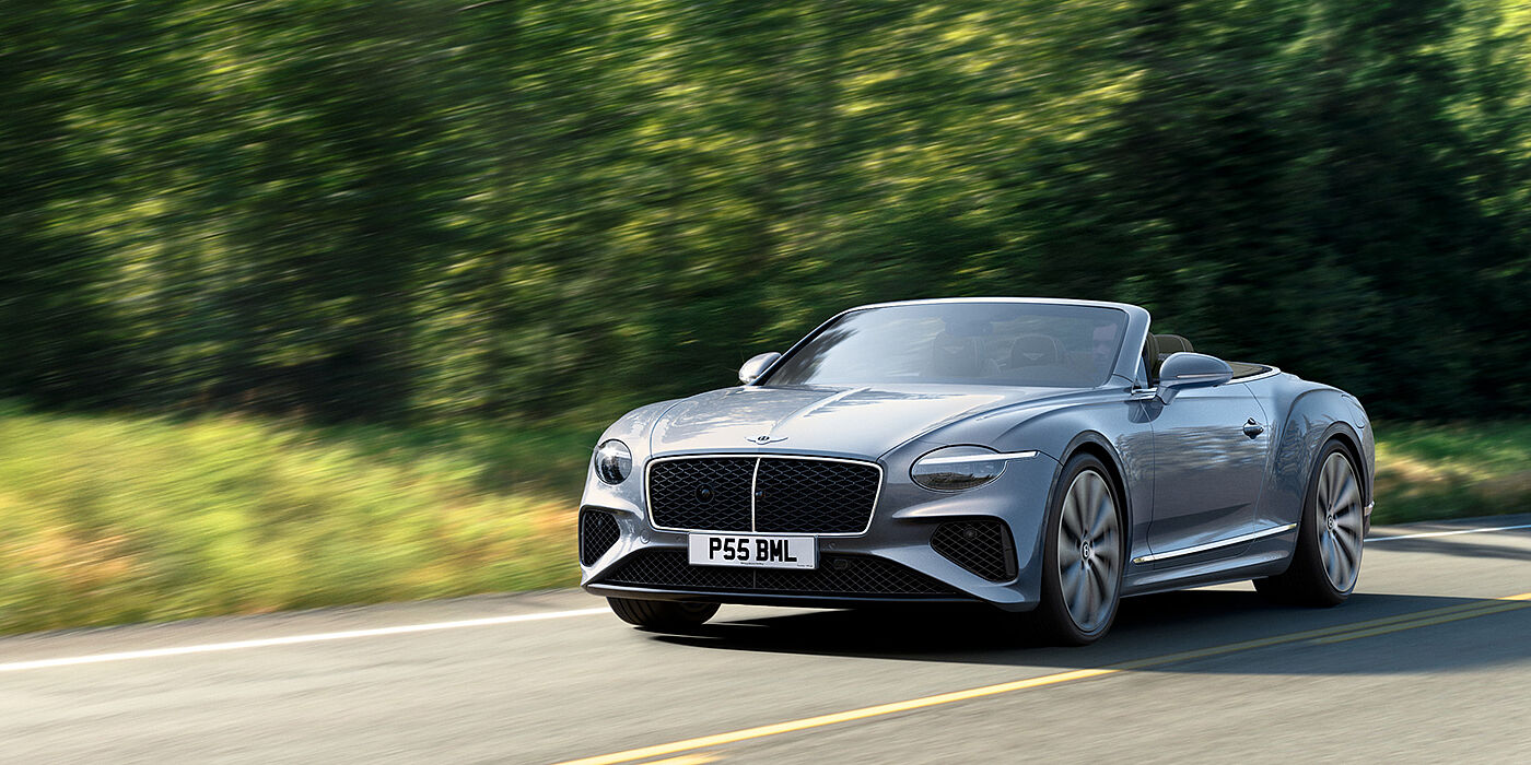 Bentley Santiago New Bentley Continental GTC convertible front view in Silverlake paint with 22 inch ten spoke wheels, driving dynamically on a country road