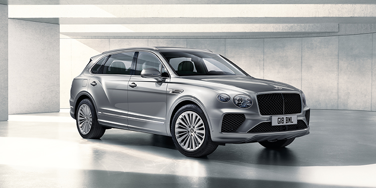 Bentley Santiago Bentley Bentayga Extended Wheelbase SUV front three quarter in Moonbeam paint with a grey background